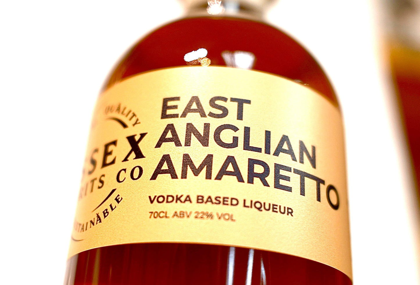 Bottle of East Anglian Amaretto with a yellow label on a white background