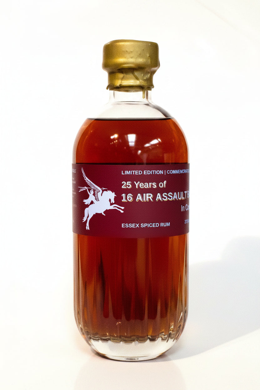A bottle of 25 Years of 16 Air Assault Essex Spiced Rum on a white background, featuring a dark red label with a white horse graphic and a gold screw cap.