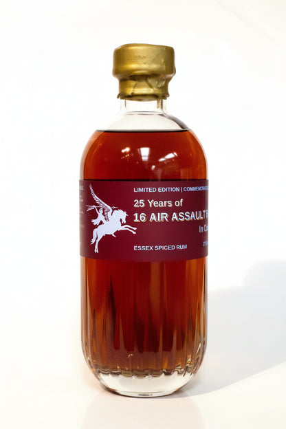 A bottle of 25 Years of 16 Air Assault Essex Spiced Rum on a white background, featuring a dark red label with a white horse graphic and a gold screw cap.