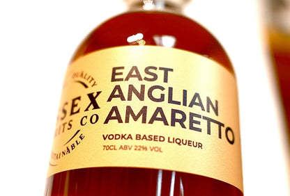 Bottle of East Anglian Amaretto with a yellow label on a white background