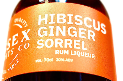 Bottle of Hibiscus Ginger Sorrel Rum Liqueur with orange label